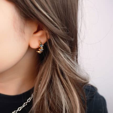 Model wearing the clip-on earrings, showcasing the fit for non-pierced ears
