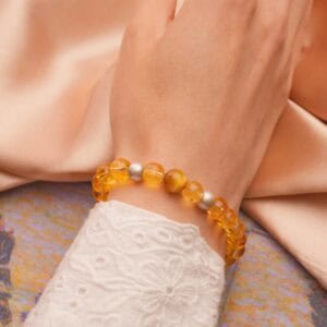 Grounding Tiger Eye & Yellow Azeztulite bracelet worn on wrist in sunlight