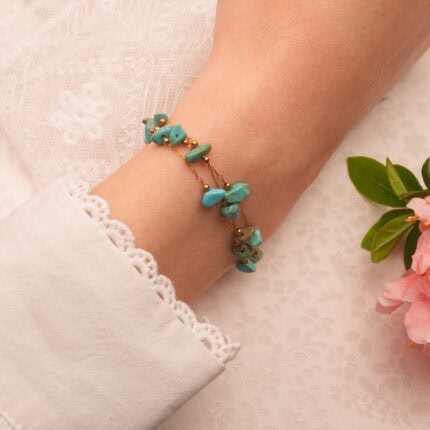 Adjustable turquoise green bracelet styled on model’s wrist for a layered look
