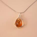 Handcrafted citrine pendant necklace with golden hues on a white or soft neutral background