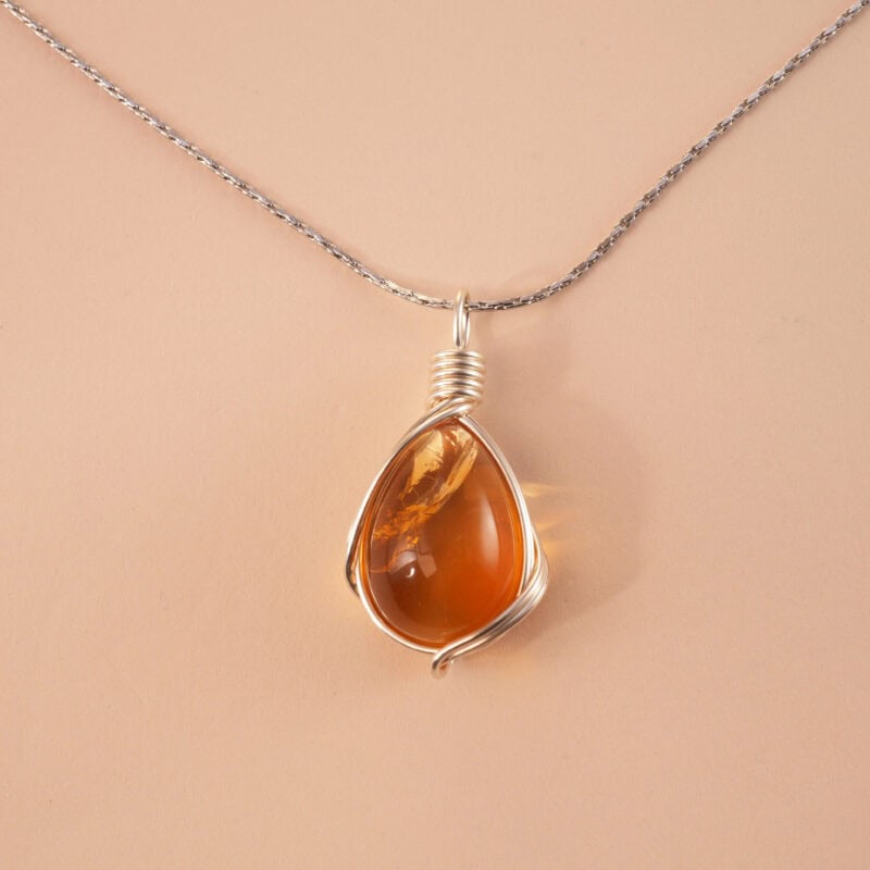 Handcrafted citrine pendant necklace with golden hues on a white or soft neutral background