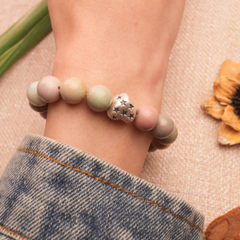 Woman wearing heart-shaped bracelet – Stylish handcrafted natural stone jewelry