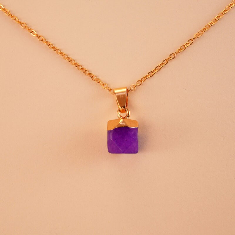 Close-up of a purple chalcedony pendant necklace showcasing its intricate design and calming energy.