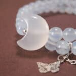 Close-up of Aquamarine Beads, Kyanite Stones, and Delicate Charms – Moon and Butterfly Design