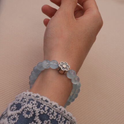 Wearing Aquamarine Crystal Bracelet with Flower Charm – Elegant and Calming