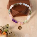 Aquarius bracelet displayed on rustic wooden surface highlighting gemstone colors