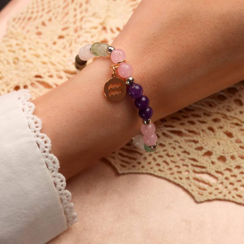 Model wearing Aquarius bracelet showcasing aquamarine and rose quartz beads