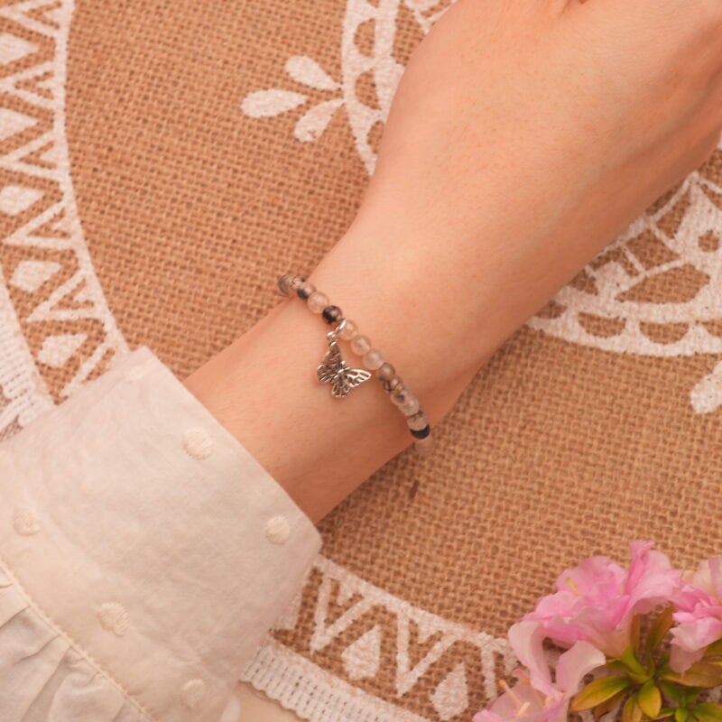 Bracelet worn on the wrist, showcasing its bold contrast and polished finish