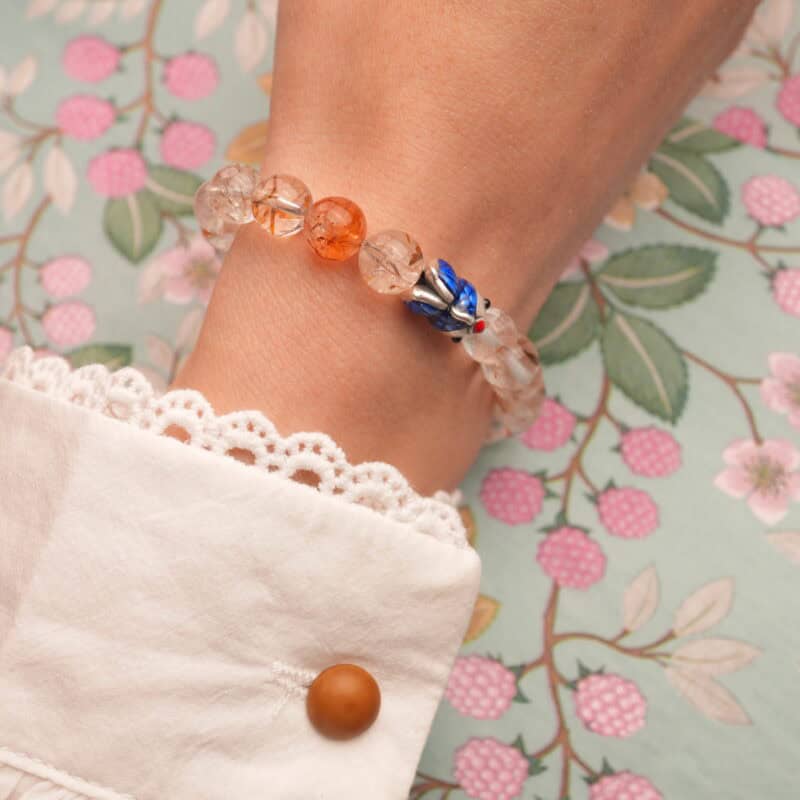 Person wearing Black Gold Obsidian Super Seven S925 Bracelet, demonstrating its protective and clarity-enhancing properties