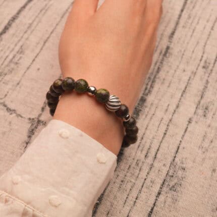 Bloodstone bracelet styled on the wrist, highlighting its natural beauty and bold color