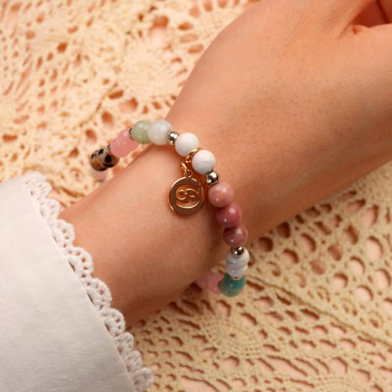 Model wearing Cancer zodiac bracelet with rose quartz and rhodochrosite