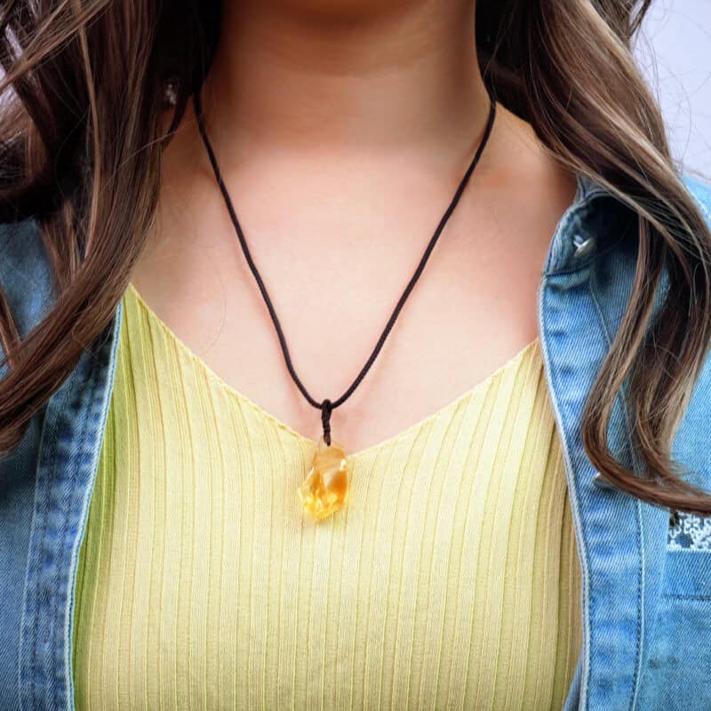 Model wearing the pendant near heart area with natural sunlight