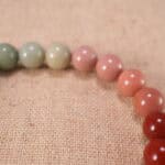 Close-up of flower charm on beaded bracelet, showcasing intricate craftsmanship