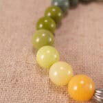 Close-up of flower charm on beaded bracelet, showcasing intricate craftsmanship