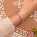 Delicate 4mm amethyst bracelet worn on wrist, ideal for everyday wear and sleep support