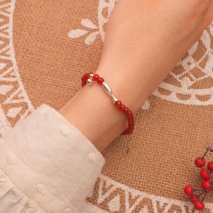 Woman wearing minimalist red agate 4mm bracelet – vibrant gemstone energy jewelry