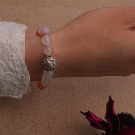 Woman wearing 8mm red agate and chalcedony bracelet – energizing natural stone jewelry