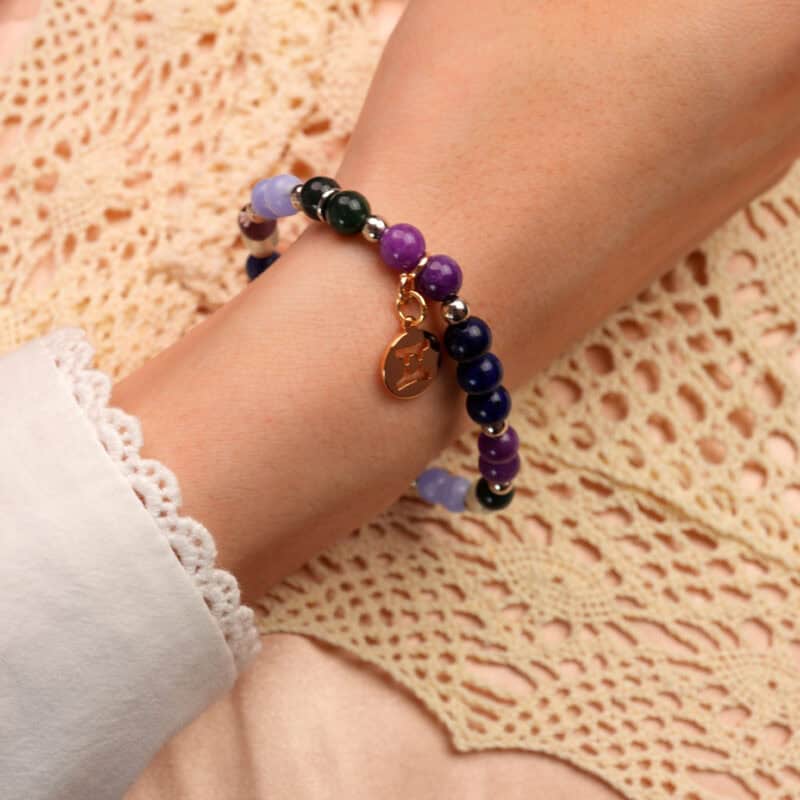 Close-up of Gemini crystal bracelet worn on wrist with soft natural lighting