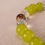 Close-up of the bracelet’s natural stone textures and shining charm details