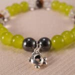 Close-up of the bracelet’s natural stone textures and shining charm details