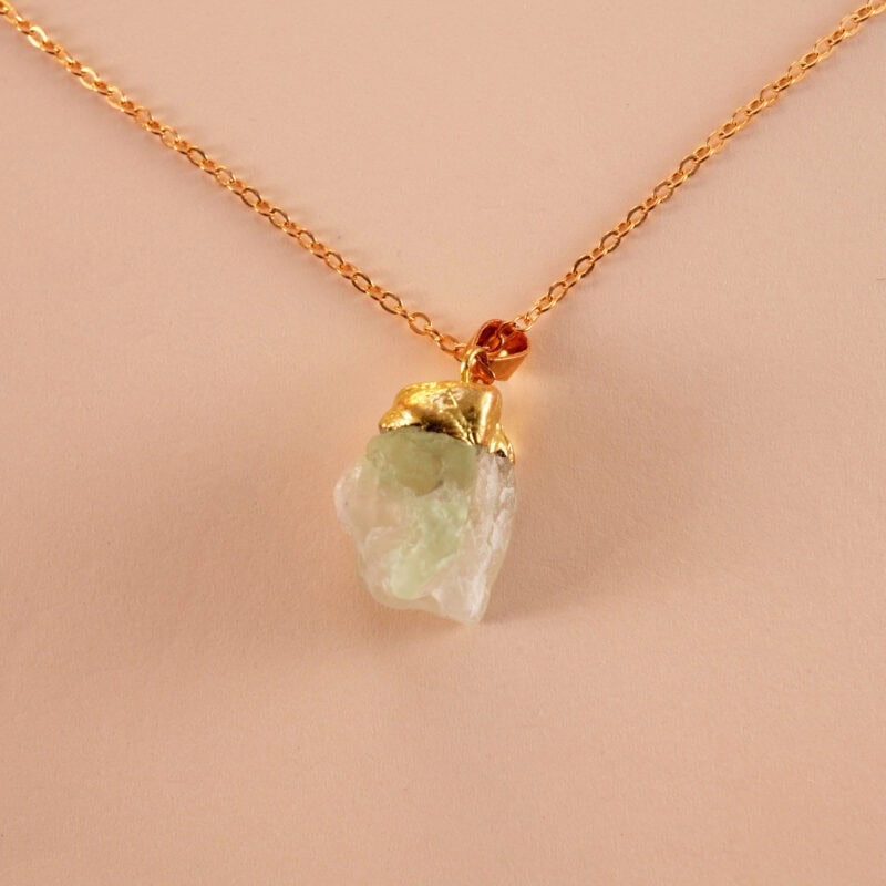 Close-up of translucent green fluorite pendant showing natural banding