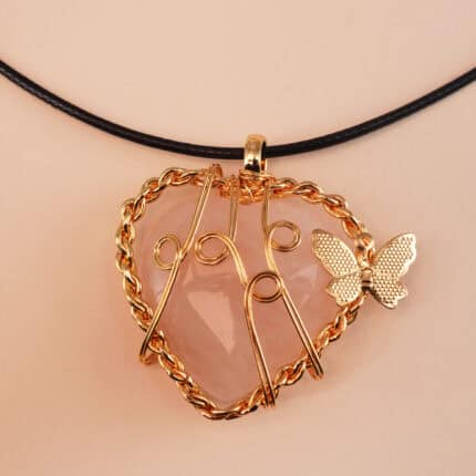Close-up of the heart-shaped polished rose quartz with delicate bail or chain