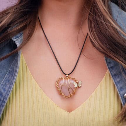Model wearing the necklace, showing the pendant resting at the heart center