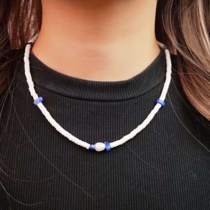 Model wearing the necklace, showing refined contrast and length