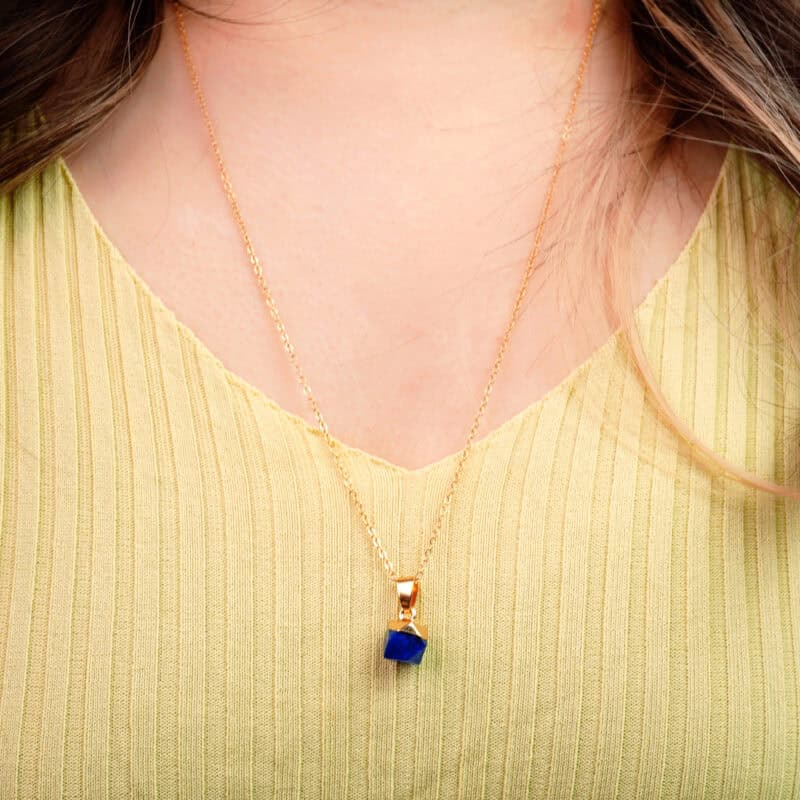 Model wearing handmade lapis lazuli pendant necklace at collarbone