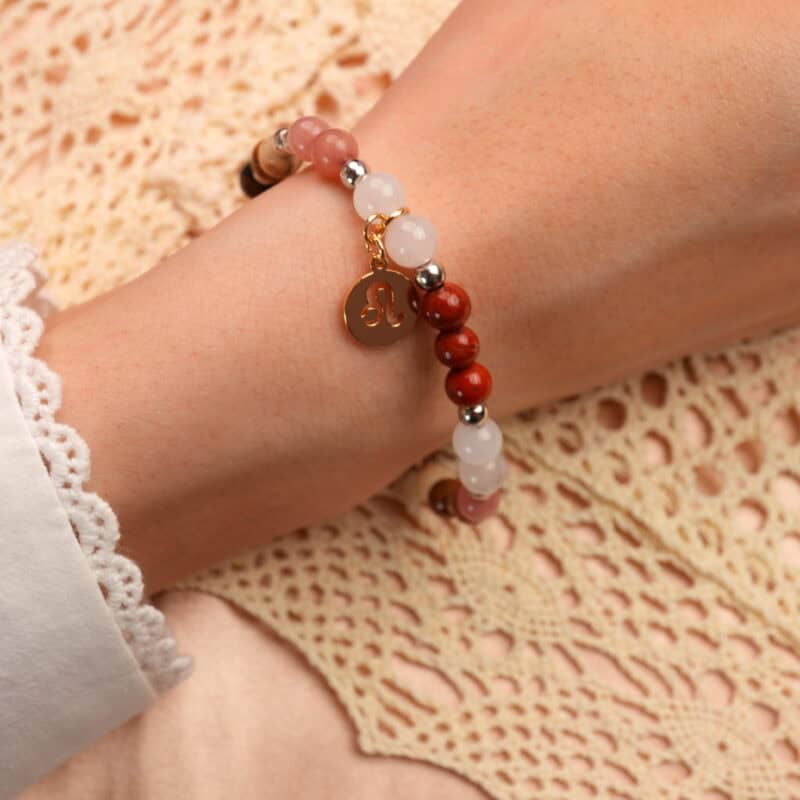 Close-up of Leo gemstone bracelet on wrist showing adjustable beads and natural stone colors