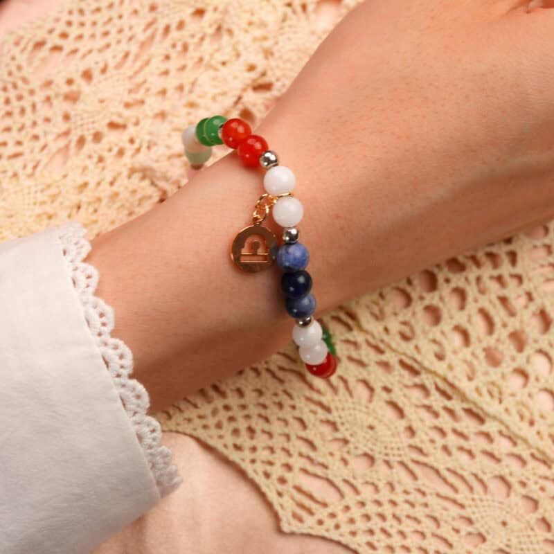 Close-up of Libra zodiac bracelet on wrist showing natural gemstone colors and elegant design