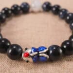 Close-up of Blue Tiger Eye Beads and Fish Charm – 8mm Gemstone Bracelet for Clarity and Energy