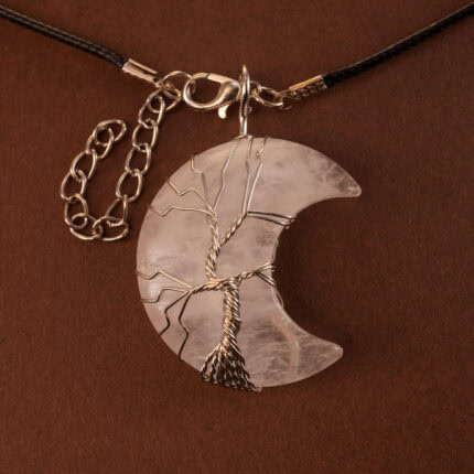 Close-up of woven clear quartz stone in crescent moon pendant setting