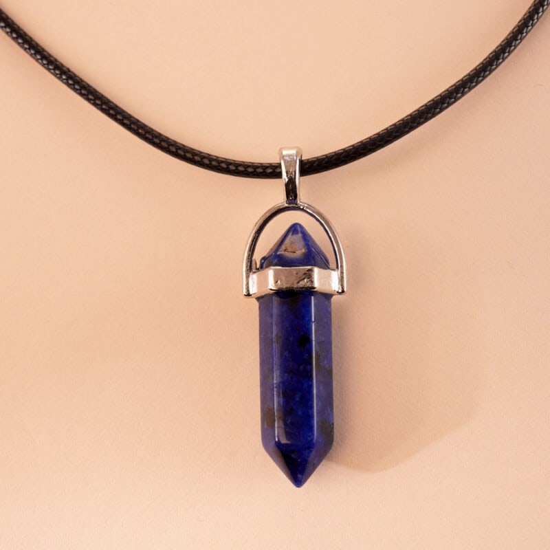 Close-up of deep blue lapis lazuli with gold pyrite inclusions in point pendant form
