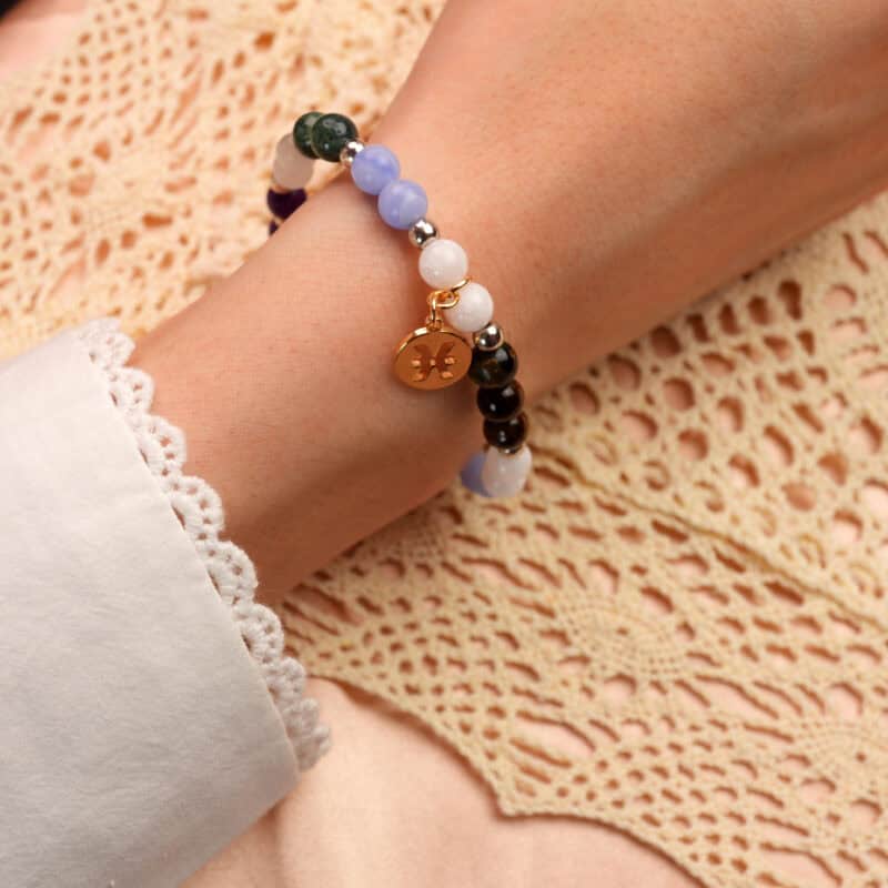 Model wearing Pisces jewelry bracelet with natural gemstone beads