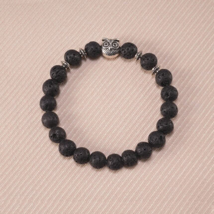 Lava stone owl bracelet with 8mm black beads and metallic owl charm on a white background.