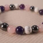 Close-up of 8mm obsidian, amethyst, and howlite beads, showing natural texture and polish.