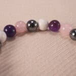 Close-up of 8mm obsidian, amethyst, and howlite beads, showing natural texture and polish.