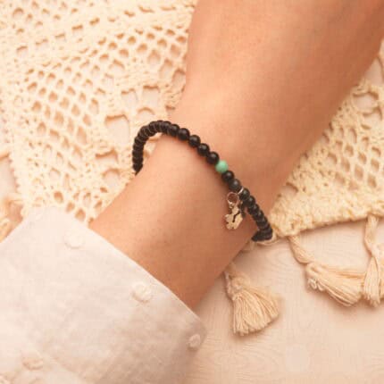 Person wearing the bracelet on wrist, showcasing its elegant and minimal 4mm design