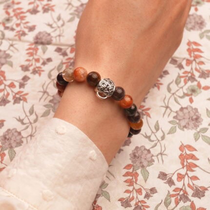 Bracelet worn on wrist with casual minimalist outfit, highlighting its elegant and grounding design