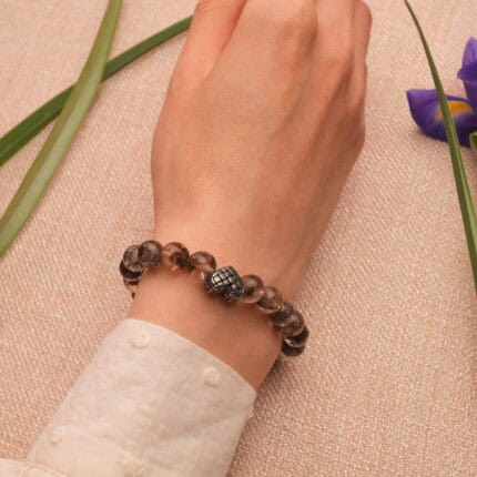 Bracelet worn on wrist, styled with minimalist outfit, showing subtle sparkle and heart charm