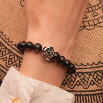 Minimalist silver obsidian bracelet worn on wrist with casual outfit