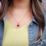 Model wearing handmade red jasper pendant necklace with earthy outfit