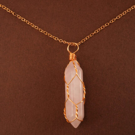 Close-up of the polished rose quartz point wrapped or capped in gold