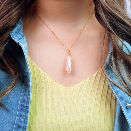 Model wearing the rose quartz pendant near the heart area