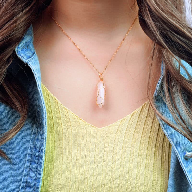 Model wearing the rose quartz pendant near the heart area