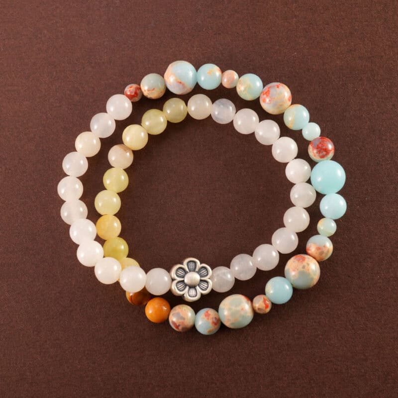 Colorful chalcedony bracelet with flower charm, displayed on white background