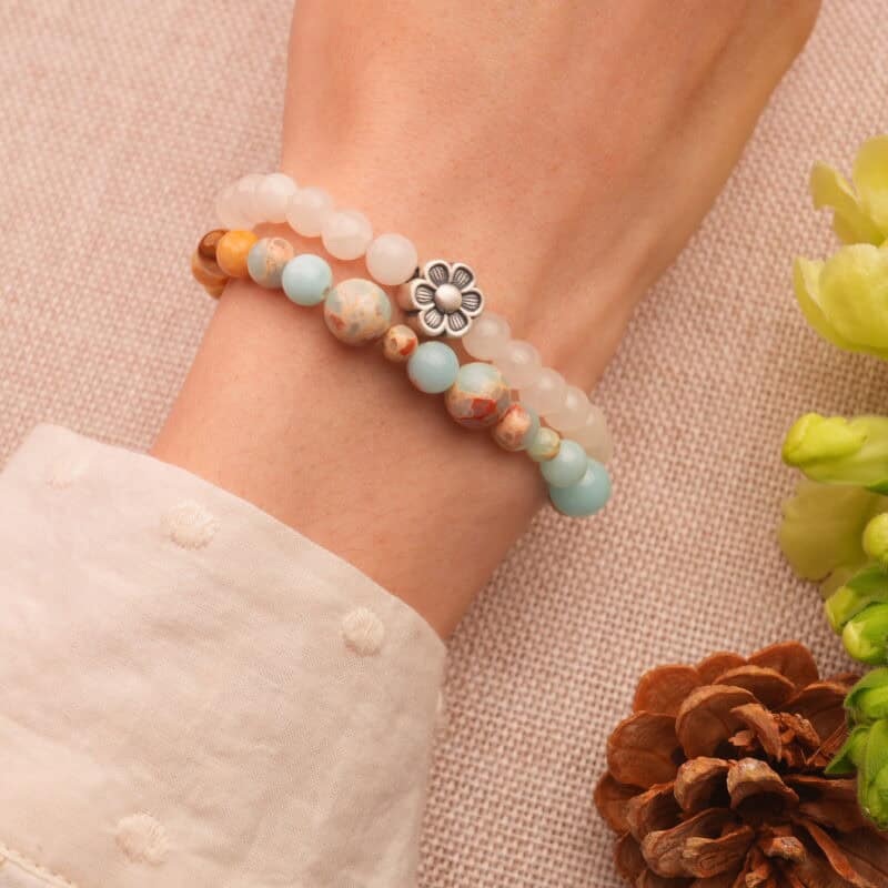 Colorful flower chalcedony bracelet worn on wrist, showing vivid tones and charm detail