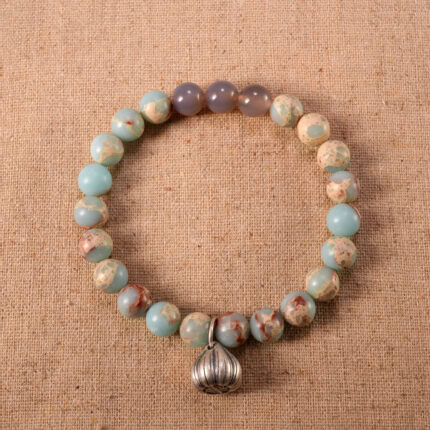Handmade gray agate and Shoushan stone bracelet with charm on a white background