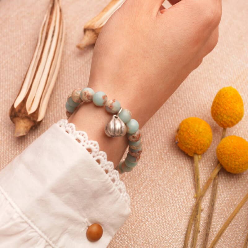 Gray agate and Shoushan stone bracelet worn on wrist, paired with minimal jewelry